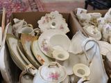 a box full of teapots and saucers in a living room