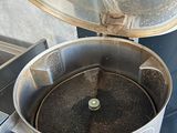 an image of a coffee grinder with a cup of coffee in it