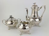 three pieces of silver tea and coffee set on a white background