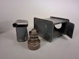 a small metal lantern sitting next to a small metal box