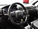 the interior of a car with a steering wheel and dashboard controls