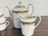 three cups and a saucer on a table