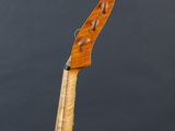 a close up of a violin on a stand against a black background