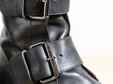 a close up of a pair of black boots with buckles on them