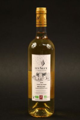 a bottle of white wine sitting on top of a table