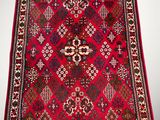 a red and black rug with a pattern on it