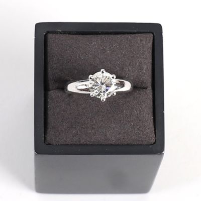 une image représentant une bague en diamant dans un écrin noir sur fond blanc