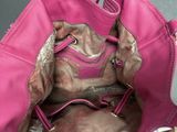 a pink purse that is sitting on a table