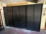 an image of a garage with a black steel door