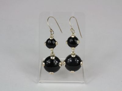 black onyx beaded earrings on clear acrylic stand