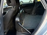 a car with the door open and the seat up