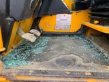 a broken glass window in the back of a construction vehicle