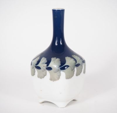 un vase bleu et blanc posé sur une surface blanche