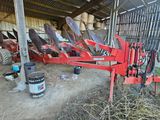 an image of a tractor and other farm equipment in a barn