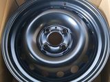 a close up of a black rim in a cardboard box