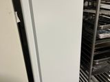 an image of a refrigerator in a kitchen with a rack of trays