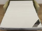a couch bed that has a mattress on top of it