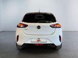 the rear end of a white car in a white room