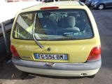 a small yellow car parked on the side of the street
