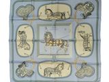 blue and yellow scarf with horses and carriages on it
