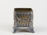 an antique silver metal planter with ornate design on a white background