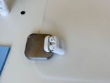 two airpods sitting on a table next to a cup of coffee