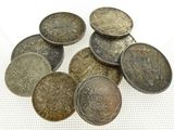 some old coins sitting on top of a white surface