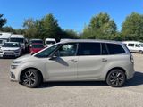 a picture of a silver minivan parked in a parking lot