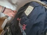 a man that is sitting on a plane with a backpack