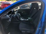 the interior of a blue car with black seats and a steering wheel
