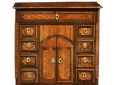 an image of a wooden cabinet with drawers and a door