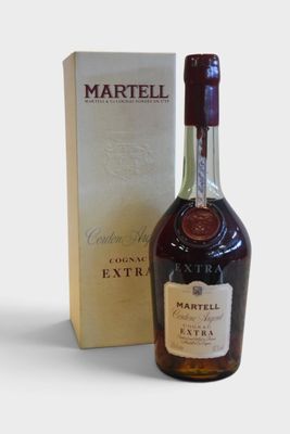 the bottle of martell extra is next to the box