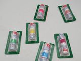 six tubes of toothpaste sitting on top of a white table