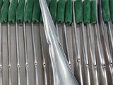 a lot of silver spoons and forks sitting on a table
