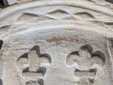 a carving of a cross on the side of a building
