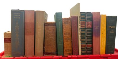many books in a red box on a white table