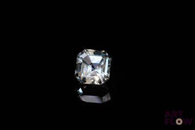a close up of a diamond on a black surface