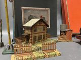 a small model of a house on a table next to a painting