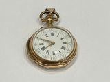 a gold pocket watch with roman numerals on it