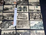 many old black and white photos of people and buildings on a table