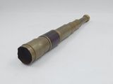 an old brass telescope with a wooden handle on a white surface