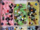 a box filled with different types of buttons and buttons
