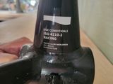 a close up of a person ' s hand holding a bottle of wine