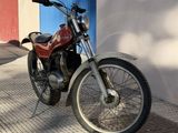 a red motorcycle parked on the side of the street