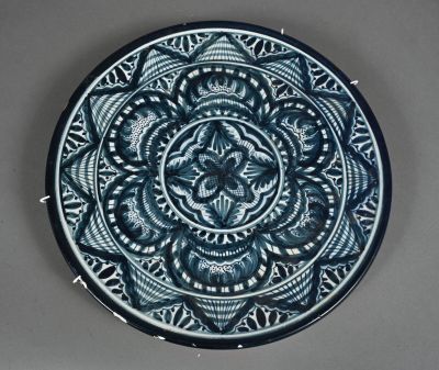 a blue and white plate with a circular design on it