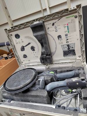 an open suitcase with tools in it sitting on a table