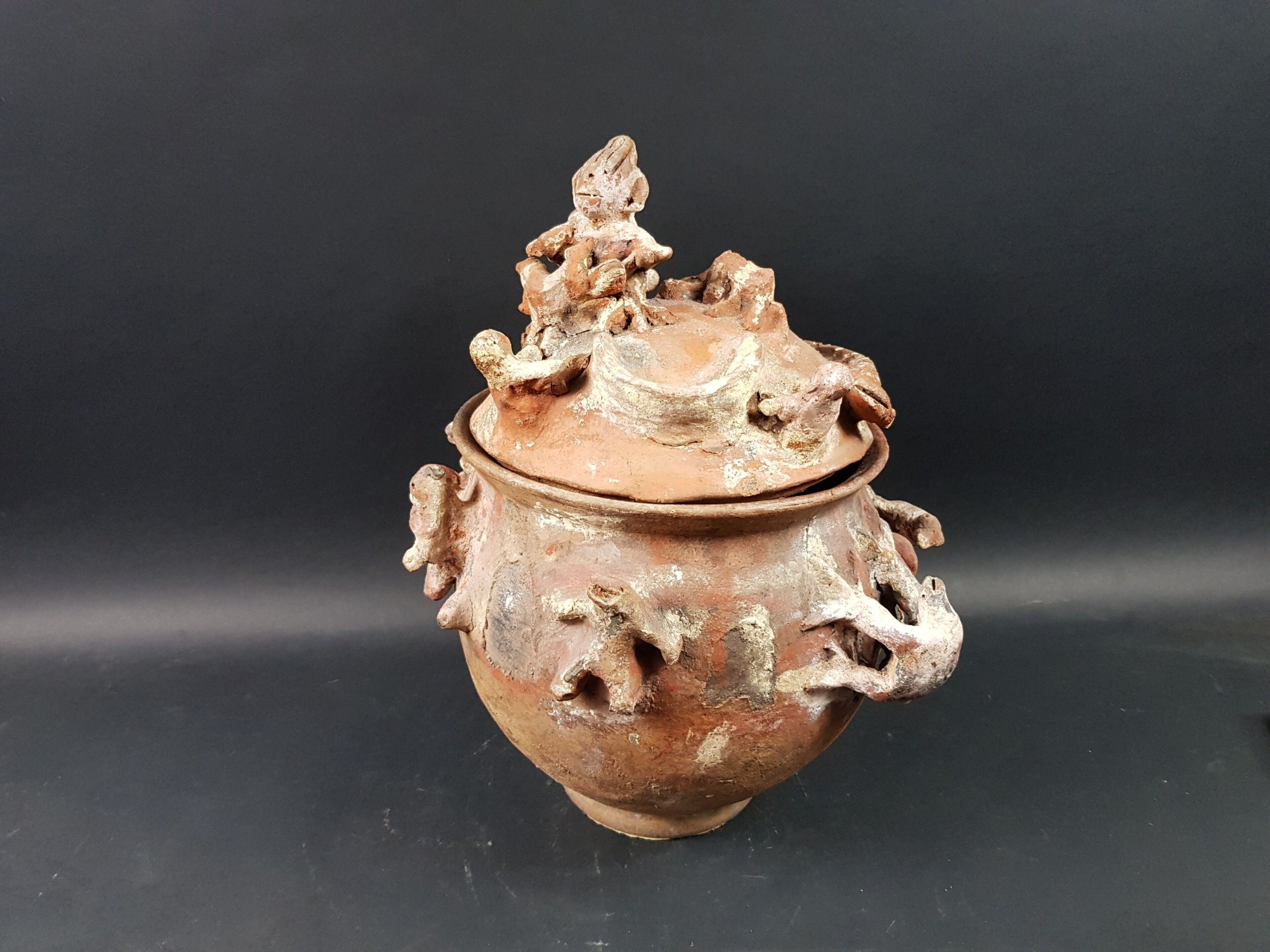Pot Ewé, Togo Terre-cuite, kaolin Intéressante urne rituelle et son couvercle à décor de personnages et de serpents. ...