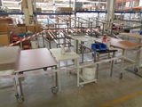 many tables and chairs in a warehouse with a lot of shelves