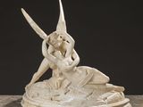 an image of a statue of a woman sitting on top of a fish