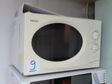 a white microwave sitting on top of a microwave oven